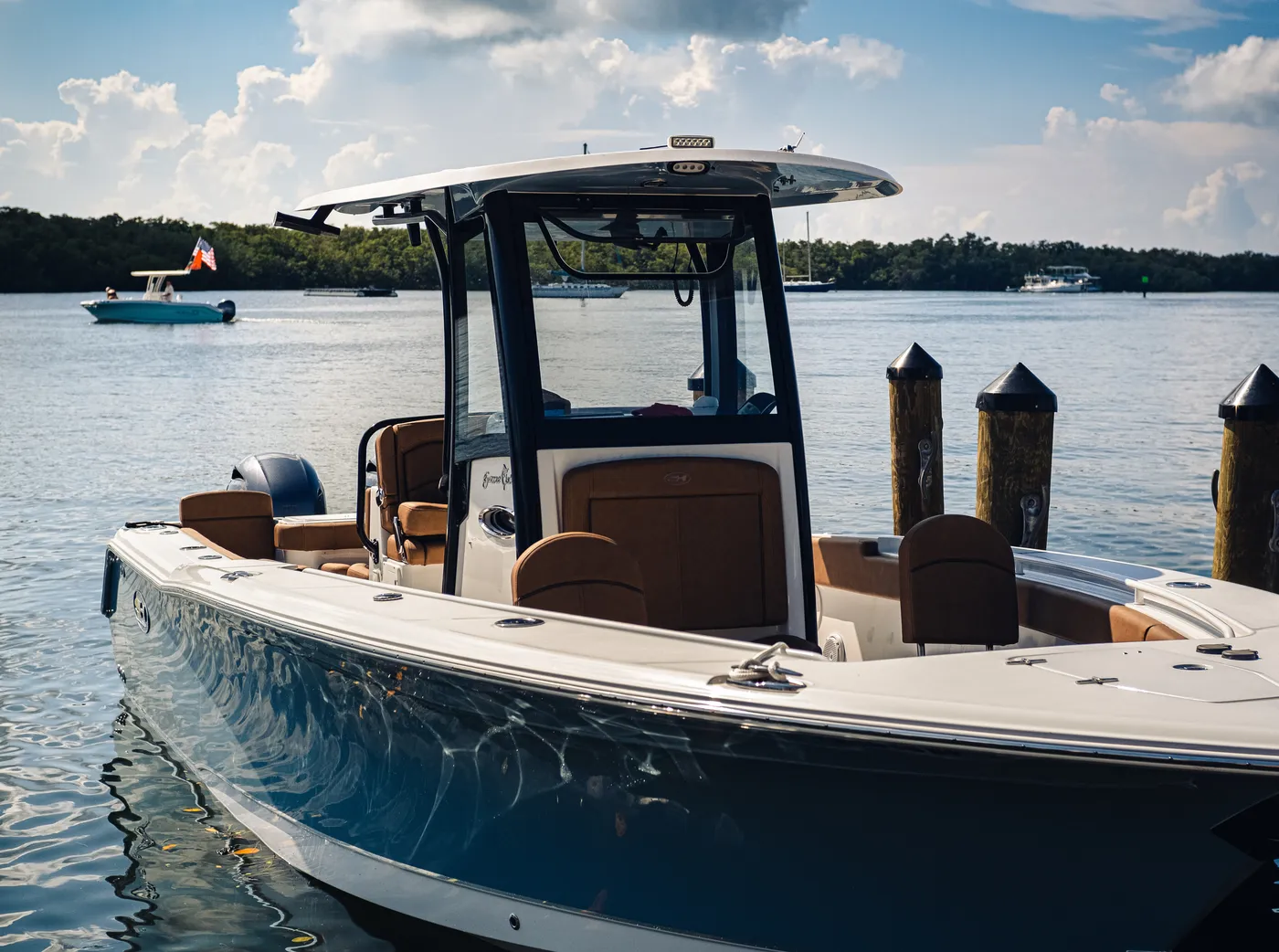 A recreational center-console powerboat moored at a dock