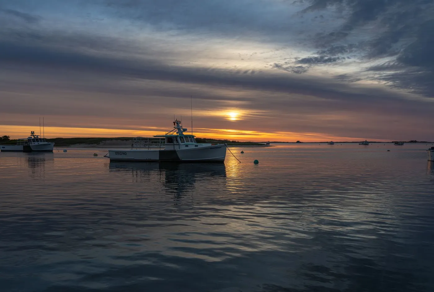 A fishing boat moored in Chatham Harbor on Cape Cod at sunset