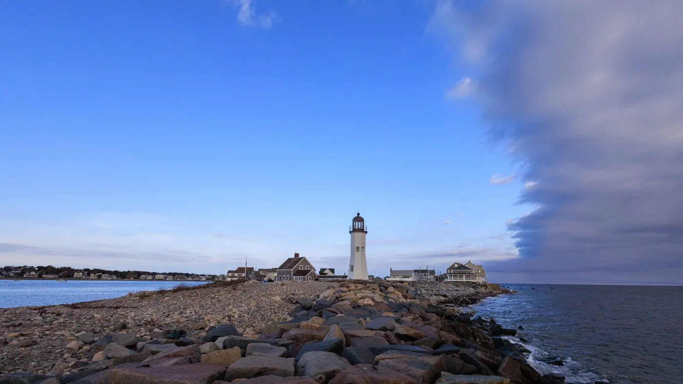 Historic Scituate Lighthouse on the rocky breakwater along the South Shore